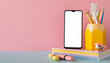 Back to school concept. Photo of school supplies on blue desk smartphone pencil holder stack of copybooks stapler and marker pens on pink wall background with blank space