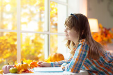 Child At Window In Autumn. Kids At Home In Fall.