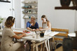 © ninelutsk - Pottery workshop in studio. People working with clay on the table. Adults learning to do ceramic plates. Pottery as hobby and leisure activity