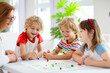 © famveldman - Family playing board game. Kids play.