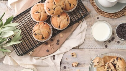 Wall Mural - Chocolate chip muffins with milk served on glass cups on white kitchen countertop.