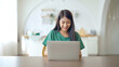 © Monster Ztudio - Young asian woman working at home. Female using computer laptop on desk at house