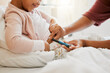 © Kay A/peopleimages.com - Testing glucose, blood pressure and diabetes of little girl with insulin treatment in bed at home. Mother checking health, wellness and blood sugar medical measurement of her daughter in a bedroom