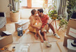 © Kay Abrahams/peopleimages.com - New home owners moving into a house showing affectionate, taking a break from painting and remodeling the living room interior design. In love and loving house wife kissing husband after decorating