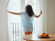 © Kay A/peopleimages.com - Awake, waking up and fresh new day or morning for a young woman opening the curtains. Back view of a carefree female with hope thinking while looking out the window in her house or at home