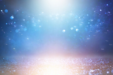 background of abstract gold and blue glitter lights. defocused