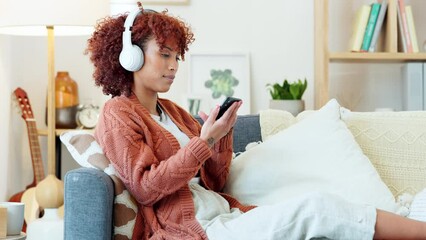 Poster - Carefree, relaxed and happy woman listening to music, enjoying favourite songs and having fun while sitting on the couch at home. Young, smiling and content black female drinking coffee and relaxing