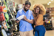 © Mediteraneo - African American couple purchasing dishes in supermarket