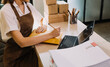 © ARMMY PICCA - Portrait of Starting small businesses SME owners, two Asian woman check online orders Selling products working with boxs freelance work at home office, sme business online small medium enterprise