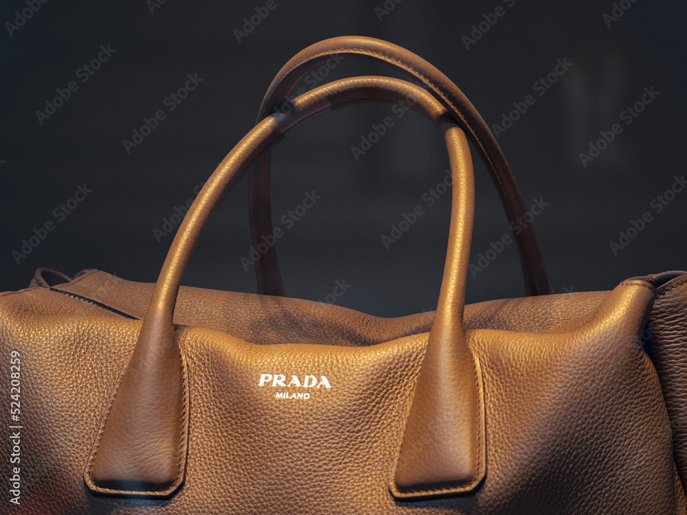 tobacco colored leather travel bag with white Prada Milano logo.Milan -  Italy, 14 August 2022 Stock Photo