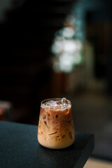 Wall Mural - Ice coffee on a table with cream being poured into it showing the texture