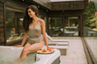 © BGStock72 - Young woman enjoying in outdoor hot tub on vacation
