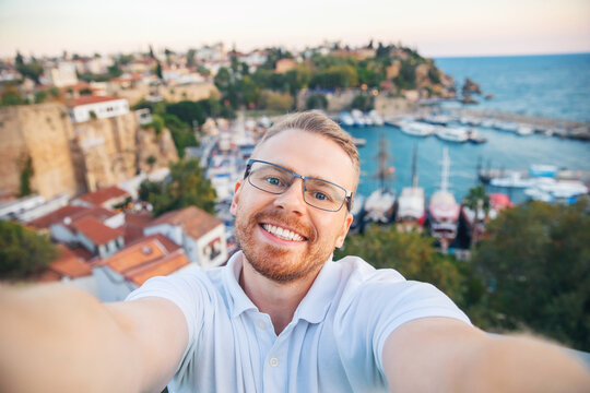 Travel selfie photo Man tourist take background Kaleici Antalya old town port, Mediterranean Sea, Turkey