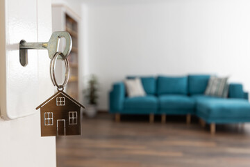 open door to a new home. door handle with key and home shaped keychain. mortgage, investment, real e