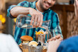 © Syda Productions - food, leisure and people concept - happy smiling man having dinner at restaurant and pouring water from jug to glass