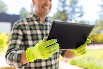 Sticker - gardening and people concept - close up of happy smiling man with tablet pc computer at summer garden