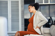 © Rido - Pregnant african business woman suffering backache