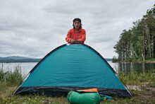 Horizontal Long Shot Of Modern Young Adult Hispanic Female Tourist Setting Up Tent Fixing Basic Frame Poles