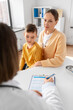 © Syda Productions - medicine, healthcare and pediatry concept - mother with little son and doctor talking at clinic