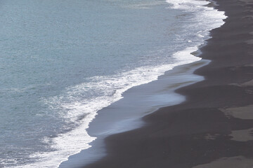 Reynisfjara - black beach in Iceland, close-up on waves