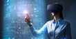 © Paulista - Young business woman wearing blue shirt and VR headset touching a virtual screen. AR and VR applications in financial industry.