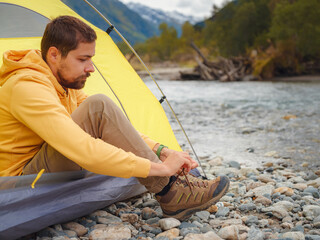 Wall Mural - trip to Caucasus mountains, Arkhyz, Teberdinsky reserve. Man traveler relaxing mountains and river in tent camping outdoor Travel adventure lifestyle concept hiking active vacations. wake up in nature