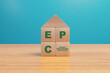 © mattiagenini - EPC energy performance certificate illustration with wooden blocks displaying a house symbol with energy ratings