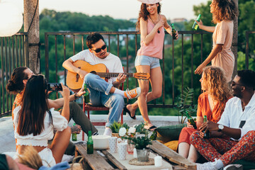 Wall Mural - Hippies having fun at the roof party.