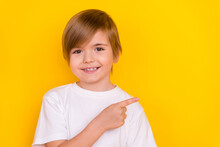 Portrait Of Attractive Trendy Cheerful Pre-teen Boy Demonstrating Copy Empty Space Look Idea Isolated Over Bright Yellow Color Background