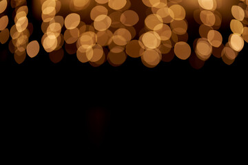 golden defocused bokeh lights on top of the image on an isolated black background. abstract magic ba