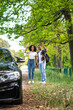 © zinkevych - A couple of hitchhikers standing on the road in the forest