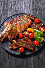 Poster - BBQ Ribs with tomatoes and chili on  black plate