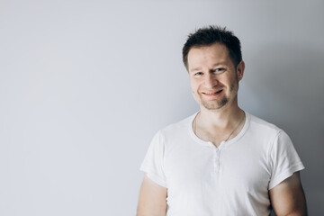 Canvas Print - Handsome guy in a white t-shirt smiling