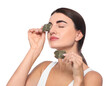 © New Africa - Beautiful woman applying green tea bags on skin under eyes against white background