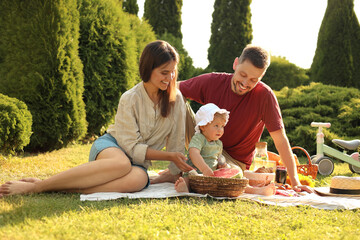 Canvas Print - Happy family having picnic in garden on sunny day