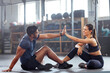 © Alexis Scholtz/peopleimages.com - Gym wellness couple high five for success or good exercise and well done gesture for reaching fitness goal. Active trainer and client woman celebrating a great workout, training or exercising session