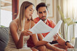 © Kay Abrahams/peopleimages.com - Budget, debt and mortgage with a couple reading bills and documents while checking their expenses and savings. Husband and wife looking worried while reading a loan application or contract together