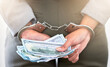 © Jade M/peopleimages.com - . Handcuffs, dollars and a business woman arrested for theft at work. Money, crime and punishment for fraud with female lawyer in prison. Cash, restraints and a criminal trying to bribe an officer.