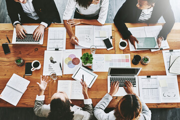 Poster - Overhead of colleagues having a marketing meeting in modern office. Above a busy workplace, coworkers brainstorm and develop strategies for a startup business, unity, planning and innovation at work
