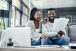 © Nicholas Felix/peopleimages.com - Happy, smiling and carefree black couple checking their finances on a laptop at home. Cheerful husband and wife excited about their financial freedom, savings, investment and future planning