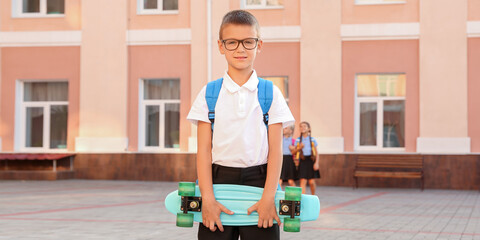 Sticker - Cute schoolboy with skateboard outdoors