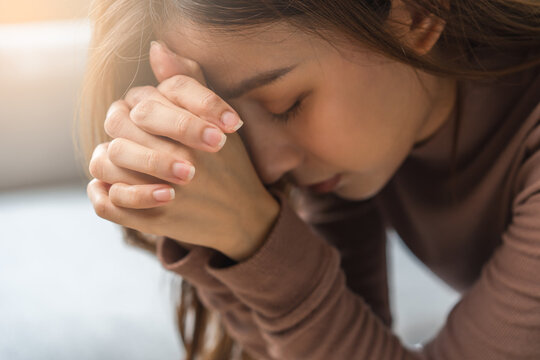 Believe faith charity, calm asian young woman show gratitude, folded hands in prayer feel grateful, meditating with her eyes closed, praying to request God for help. Religious, forgiveness concept.