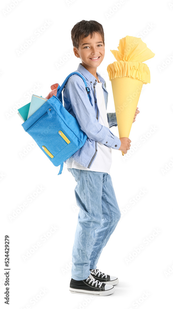 Little boy with yellow school cone and backpack on white background