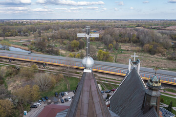 Wall Mural - Cross on a tower of Siekierki Sanctuary of Our Lady and Trasa Siekierkowska street in Warsaw, Poland