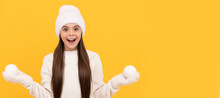 Winter Girl. Amazed Child In Winter Hat And Gloves Hold Snowballs On Yellow Background. Banner Of Christmas Child Girl, Studio Kid Winter Portrait With Copy Space.