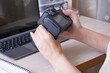 © Alina - Studying online photography lessons. Female hands holding SLR camera at desktop with laptop