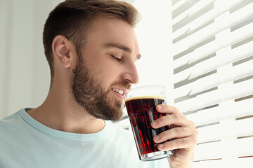 Sticker - Handsome man with cold kvass indoors. Traditional Russian summer drink