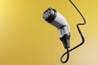 Electric vehicle (EV) type 2 charger isolated on yellow background