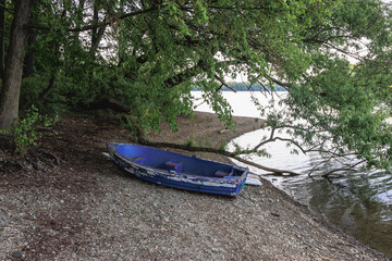 Poster - Old boat on the shore of Terlicko dam lake on River Stonavka in Terlicko in Czech Republic