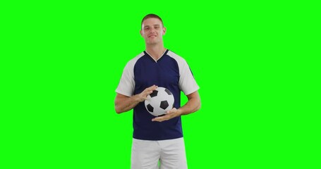 Poster - Video of happy caucasian male soccer player with ball on green screen background